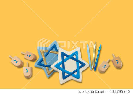 Hanukkah-themed cookies shaped as stars and dreidels 133795560