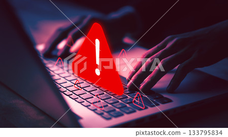 Cybersecurity warning with red alert sign on laptop, symbolizing online threat, hacking danger, virus alert, cyber attack, data protection, and digital security issues. Cybersecurity warning with red alert sign on laptop, symbolizing online threat, hacking danger, virus alert, cyber attack, data protection, and digital security issues. 133795834