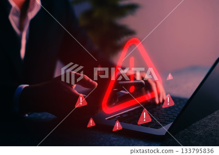 Cybersecurity alert with warning icon displayed on screen, representing digital threat, hacking risk, malware, phishing, and internet data breach in a modern online environment. Cybersecurity alert with warning icon displayed on screen, representing digital threat, hacking risk, malware, phishing, and internet data breach in a modern online environment. 133795836
