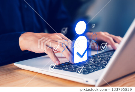 Business hand using laptop with digital user icons and check marks, representing online identity verification, HR selection, recruitment system, and secure user management for modern digital Business hand using laptop with digital user icons and check marks, representing online identity verification, HR selection, recruitment system, and secure user management for modern digital 133795839