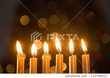 Close-up of lit candles in a row burning Close-up of lit candles in a row burning 133796022