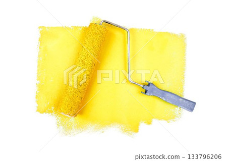 Yellow paint roller over white background 133796206