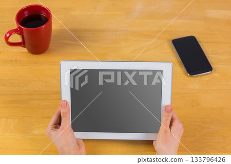 Businesswoman using tablet at desk Businesswoman using tablet at desk 133796426