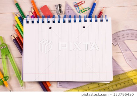 Flat design showing notebook on wooden desk surrounded by pencils, rulers, compass, copy space Flat design showing notebook on wooden desk surrounded by pencils, rulers, compass, copy space 133796450
