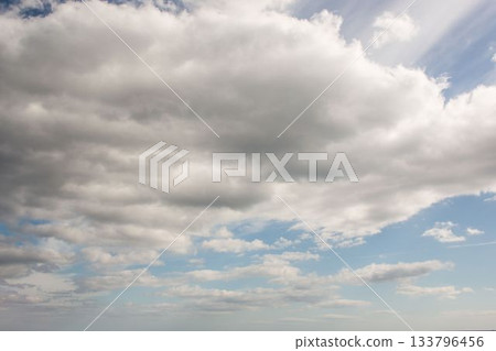Large cumulus cloud formation is dominating flat design sky illustration, with pale blue sky gaps Large cumulus cloud formation is dominating flat design sky illustration, with pale blue sky gaps 133796456