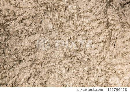 Textured rocky soil surface is being shown in flat design arid ground, highlighting fine cracks 133796458