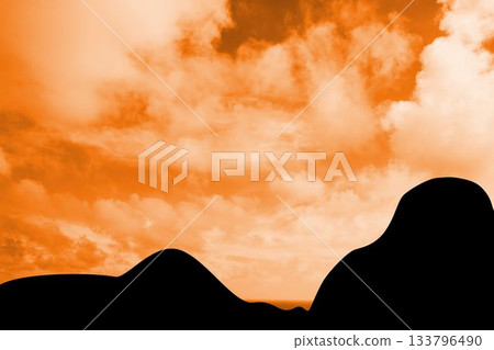 Silhouetted rolling hills are creating minimalist flat design scene with warm orange sky and clouds Silhouetted rolling hills are creating minimalist flat design scene with warm orange sky and clouds 133796490