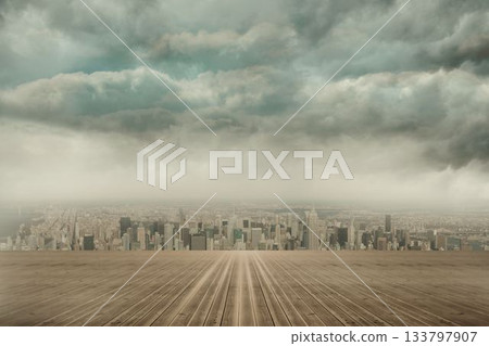 wooden deck platform is guiding gaze toward city skyline under looming storm clouds 133797907