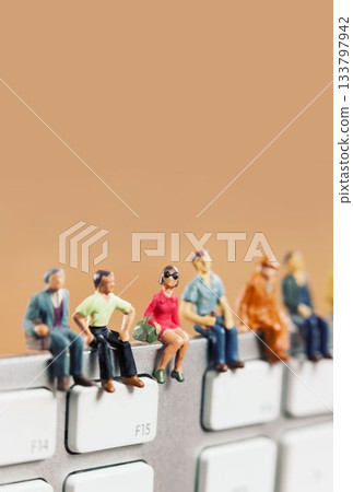 Figurines on laptop keyboard Figurines on laptop keyboard 133797942