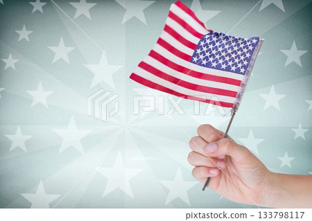 Cropped image of hand holding American flag 133798117