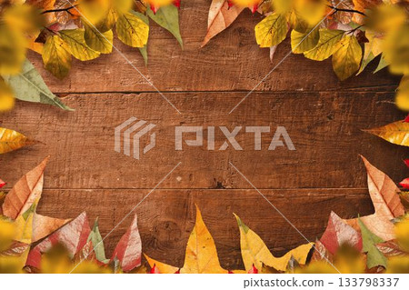 Flat design wooden plank surface is forming warm autumn frame with scattered colorful leaves Flat design wooden plank surface is forming warm autumn frame with scattered colorful leaves 133798337
