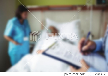 Doctors taking care of patient in hospital room Doctors taking care of patient in hospital room 133798357