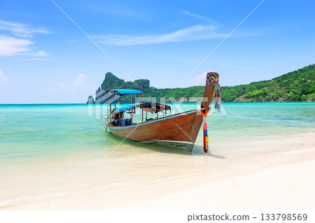 Landscape with thai longtail boat on white sand beach in Phi Phi island, Thailand. Travel summer concept. Landscape with thai longtail boat on white sand beach in Phi Phi island, Thailand. Travel summer concept. 133798569