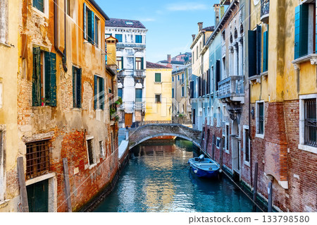 Beautiful view of colorful facades of old houses, canals and bridges in Venice, Italy. Venice canal with docked boat, Italy. Beautiful view of colorful facades of old houses, canals and bridges in Venice, Italy. Venice canal with docked boat, Italy. 133798580
