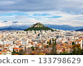View of Lycabettus mount from Acropolis hill in Athens, Greece. Cityscape of historical town of Athens with old and modern Greek houses against dramatic sky. 133798629