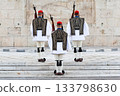 Three members of the Presidential Guard soldiers (evzones) in the city center of the Greek capital, Athens, Greece. Concept of historical traditional ceremony of elite military. 133798630