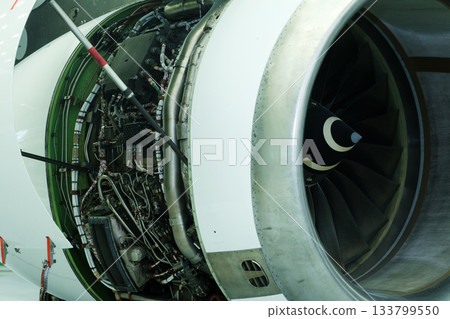 Jet engine interior view showcasing detailed components and engineering design in an aircraft maintenance facility during a bright day 133799550