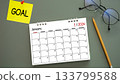 calendar of New Year 2026, January with word GOAL on post-it paper pin on green background, pencil and eyeglasses beside. symbolize New Year targets, resolutions, strategy, progress, and fresh starts 133799588