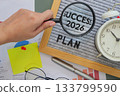 hand holding a magnifying glass points to the word Success 2026 on letter board with text plan, symbolizing fresh goals, motivation, and starts new year personal fresh planning. 133799590