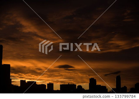 Silhouette city against cloudy sky during sunset Silhouette city against cloudy sky during sunset 133799784