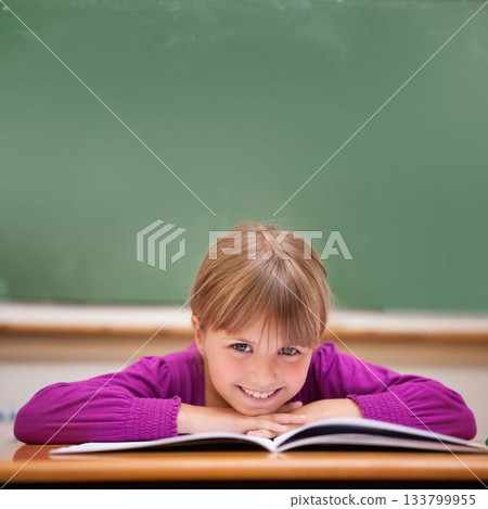 Cute pupil sitting at desk 133799955