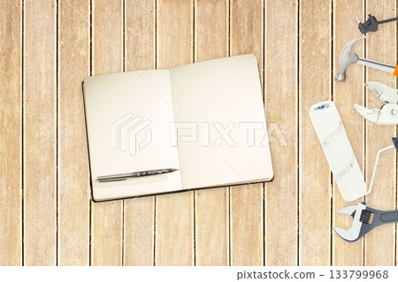 Tools and notepad on wooden background 133799968