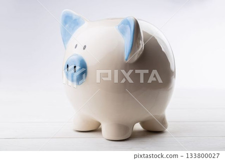 Close-up of piggy bank on wooden table 133800027