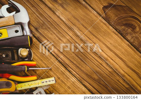 Cluster of hand tools is being arranged along wooden plank surface in flat design, copy space Cluster of hand tools is being arranged along wooden plank surface in flat design, copy space 133800164