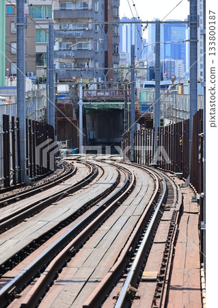 The Tokyo Sakura Tram tracks stretch down the slope towards Chitosebashi Bridge 133800187