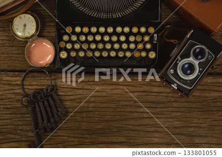 Typewriter, camera and clock on table 133801055