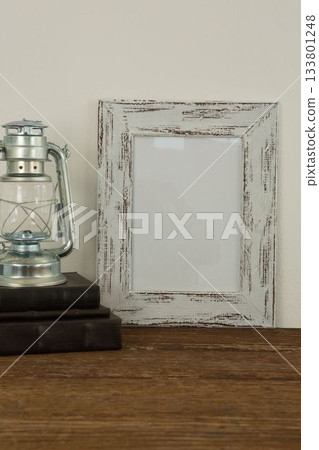 Photo frame and lantern on table Photo frame and lantern on table 133801248