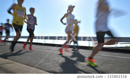 Marathon: Marathon runners running up a hill with slow shutter Marathon: Marathon runners running up a hill with slow shutter 133801516