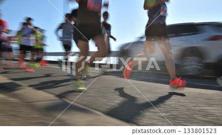 Marathon: Marathon runners running up a hill with slow shutter Marathon: Marathon runners running up a hill with slow shutter 133801523