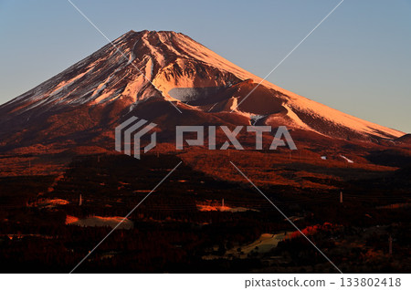 Mount Fuji and the Hoei crater blazing in the morning glow from the Torigoki Plateau Observatory on Mount Echizen in the Ashitaka Mountains 133802418