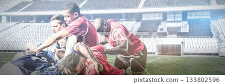 Multiracial aggressive male players scrumming in stadium during match Multiracial aggressive male players scrumming in stadium during match 133802596