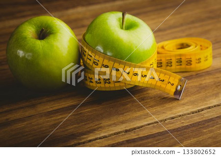 Green apples and measuring tape 133802652