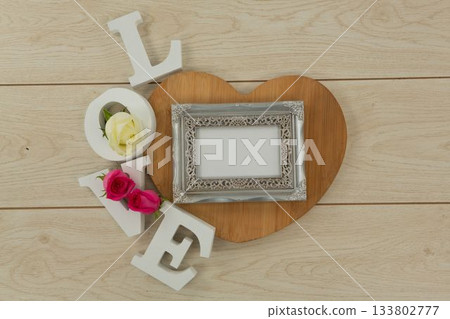 Photo frame with love alphabet on table Photo frame with love alphabet on table 133802777