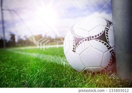 Close-up of soccer ball near a goal post 133803012
