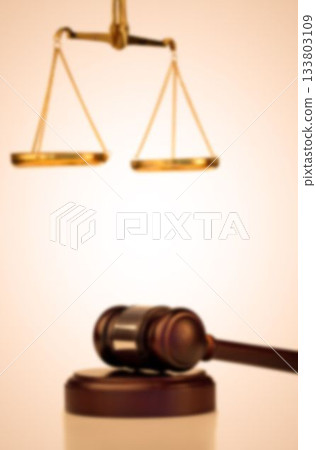 Close-up of gavel with hanging weight scale 133803109