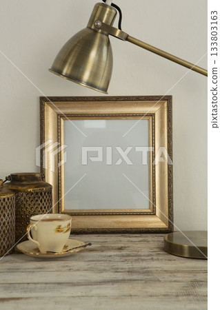 Photo frame and coffee cup on table 133803163