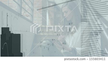 Using tablet, businesswoman analyzing financial graphs and data with image 133803411