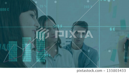 Brainstorming three colleagues writing on sticky note covered whiteboard in meeting room 133803433