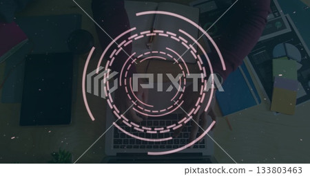 Circular digital interface image over person typing on laptop at desk Circular digital interface image over person typing on laptop at desk 133803463