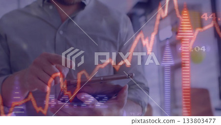 Using tablet with financial data and stock market graph, business person analyzing 133803477
