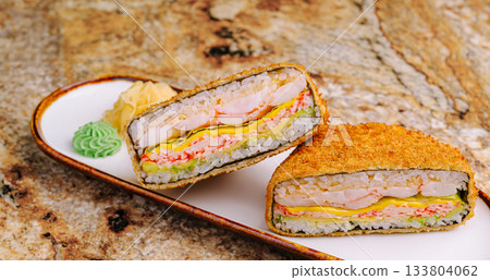 Crispy sushi sandwich served on a white plate with colorful garnishes Crispy sushi sandwich served on a white plate with colorful garnishes 133804062