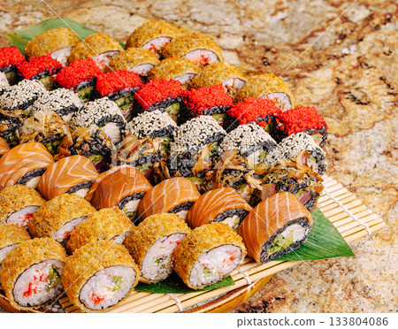 Colorful sushi platter served on a bamboo mat with various flavors 133804086
