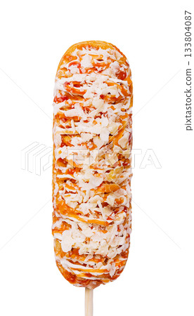 Delicious corn dog on a stick featuring sweet toppings and crunchy texture 133804087