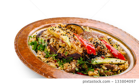 Sizzling rice dish with grilled vegetables and spices served on a platter 133804097