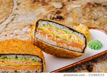 Sushi roll with layers of fresh ingredients served on a plate Sushi roll with layers of fresh ingredients served on a plate 133804155
