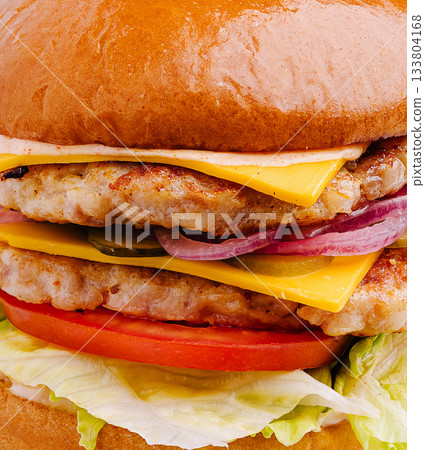 Delicious stacked burger with cheese, lettuce, and fresh vegetables 133804168